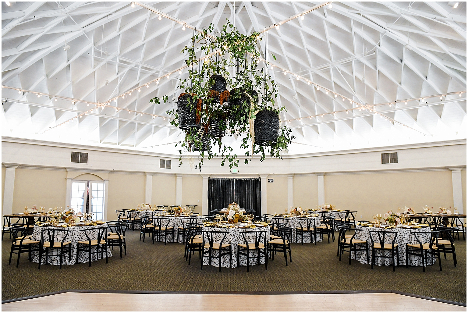 Casino San Clemente ballroom decorated for a wedding reception featuring floral design by studio la Palma and event design by Michelle Garibay Events