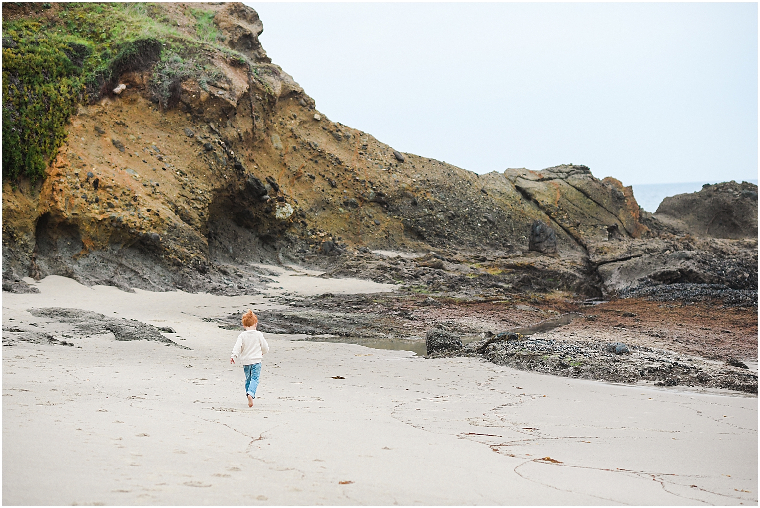 little boy explores tide pools in Laguna Beach